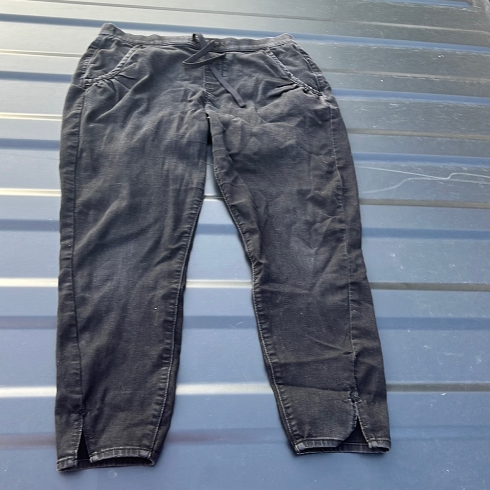 Black signature Levi Jogger pants. Slit at ankle.